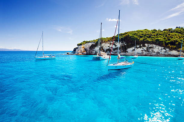 A sailboat on a clear blue Mediterranean sea